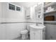 Basement bathroom featuring bright white tiling, vanity and open shelving at 2684 Taft Ct, Lakewood, CO 80215