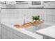 Relaxing bathtub with a bamboo tray holding bath essentials and a decorative plant at 2684 Taft Ct, Lakewood, CO 80215