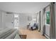 Comfortable bedroom features bright windows, wood floors, a sitting chair, and neutral decor at 2684 Taft Ct, Lakewood, CO 80215