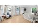 Spacious bedroom with light wood floors, two windows, and tasteful decor at 2684 Taft Ct, Lakewood, CO 80215
