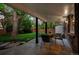 Relaxing covered patio with ample seating and serene views of the lush backyard at 2684 Taft Ct, Lakewood, CO 80215