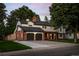 Beautiful brick and white two-story home with mature landscaping, attached garage, and a spacious driveway at 2684 Taft Ct, Lakewood, CO 80215