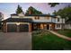 Stunning home boasts a brick exterior, white siding, attached garage, and a beautifully landscaped front yard at 2684 Taft Ct, Lakewood, CO 80215