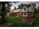 Charming two-story home on a lush green lawn, featuring a brick facade, white trim, and an attached garage at 2684 Taft Ct, Lakewood, CO 80215