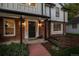 Inviting front entrance with a decorative door, sidelights, and brick accents, complemented by lush landscaping at 2684 Taft Ct, Lakewood, CO 80215