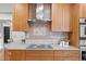 Stylish kitchen showcases wooden cabinets, a mosaic tile backsplash, and modern appliances for a gourmet experience at 2684 Taft Ct, Lakewood, CO 80215
