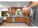 Well-appointed kitchen with stainless steel appliances, wooden cabinets, and a cozy breakfast nook at 2684 Taft Ct, Lakewood, CO 80215