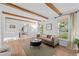Bright living room boasts wood beams, large windows, and neutral decor, creating a cozy atmosphere at 2684 Taft Ct, Lakewood, CO 80215