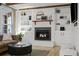 Charming living room featuring a brick fireplace, built-in shelves, and comfortable seating at 2684 Taft Ct, Lakewood, CO 80215
