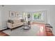 Inviting living room features hardwood floors, large windows, and cozy seating, perfect for relaxation at 2684 Taft Ct, Lakewood, CO 80215