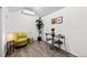 Cozy shed interior featuring stylish furniture, artwork, and an air conditioning unit at 2684 Taft Ct, Lakewood, CO 80215