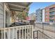 Cozy patio with stone accents, string lights, and city views at 4400 S Quebec St # 101N, Denver, CO 80237