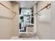 Ensuite bathroom with glass enclosed shower, decorative tiling, and modern fixtures within a walk-in closet at 4400 S Quebec St # 101N, Denver, CO 80237