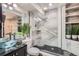 Bright bathroom showcasing a glass shower, modern vanity with a vessel sink, and stylish tile work at 4400 S Quebec St # 101N, Denver, CO 80237