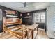 Rustic bedroom features a wooden bed frame, dark wood paneling, and a decorative metal ceiling at 4400 S Quebec St # 101N, Denver, CO 80237