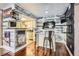 Kitchen area featuring a white island, stainless steel appliances, and hardwood floors at 4400 S Quebec St # 101N, Denver, CO 80237
