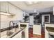 Kitchen with stainless steel appliances, a black sink, and an island at 4400 S Quebec St # 101N, Denver, CO 80237