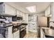 Bright kitchen featuring stainless steel appliances, black counters, and vintage cabinets at 4400 S Quebec St # 101N, Denver, CO 80237