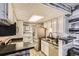 Cozy kitchen featuring white cabinets, modern appliances, and unique ceiling design at 4400 S Quebec St # 101N, Denver, CO 80237