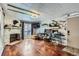 Cozy living room with a fireplace, wood floors, and a bar area for entertaining at 4400 S Quebec St # 101N, Denver, CO 80237
