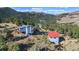 Aerial view of a charming property nestled in the mountains, showcasing the home and its unique setting with mountain views at 319 Camino Bosque, Boulder, CO 80302