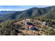An aerial view of homes nestled within a lush mountain forest at 319 Camino Bosque, Boulder, CO 80302