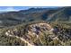 A high-angle view of homes surrounded by trees on a mountain slope at 319 Camino Bosque, Boulder, CO 80302