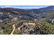 Panoramic aerial view of homes nestled in a lush, mountainous landscape with distant horizon at 319 Camino Bosque, Boulder, CO 80302