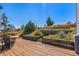 Back deck with flower beds surrounded by mountain views at 319 Camino Bosque, Boulder, CO 80302