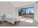 Bedroom features neutral walls, vaulted ceilings, and sliding glass door leading to a balcony at 319 Camino Bosque, Boulder, CO 80302