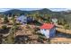Multi-level home with a striking red-roofed garage and stairs leading up to the main house at 319 Camino Bosque, Boulder, CO 80302