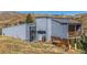 Exterior view of home with deck overlooking landscaped yard at 319 Camino Bosque, Boulder, CO 80302