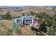 Stunning view of the exterior of a mountainside home with a wood deck and views of the mountains and surrounding trees at 319 Camino Bosque, Boulder, CO 80302