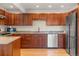 Well-appointed kitchen featuring granite countertops, stainless steel appliances, hardwood floors, and wooden cabinets at 319 Camino Bosque, Boulder, CO 80302