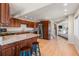 Open kitchen area with stainless steel appliances, a granite island, hardwood floors, and a view into the living room at 319 Camino Bosque, Boulder, CO 80302