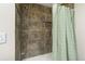 Tiled shower featuring a shower head, stylish tiles and a shower curtain at 319 Camino Bosque, Boulder, CO 80302