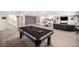 Spacious finished basement featuring a billiards table, media area and neutral decor at 11346 Kittredge St, Commerce City, CO 80022