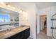 Bathroom with double vanity, soaking tub, shower, and large mirror. Includes walk-in closet at 11346 Kittredge St, Commerce City, CO 80022