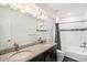 Bathroom featuring double sinks, granite counters, decorative lighting and shower at 11346 Kittredge St, Commerce City, CO 80022