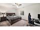 Comfortable bedroom with ceiling fan, desk, modern chair and large bed at 11346 Kittredge St, Commerce City, CO 80022