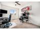 Modern bedroom with gaming setup, desk, comfortable chair, and ample natural light at 11346 Kittredge St, Commerce City, CO 80022