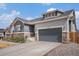 Home exterior with a two-car garage and inviting curb appeal at 11346 Kittredge St, Commerce City, CO 80022