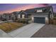 Charming two-story home with stone accents, landscaped yard, and driveway at 11346 Kittredge St, Commerce City, CO 80022