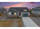 Charming two-story home with stone accents, landscaped yard, and driveway at 11346 Kittredge St, Commerce City, CO 80022