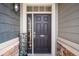Inviting front door featuring dark wood, sidelight, and stone accents at 11346 Kittredge St, Commerce City, CO 80022