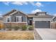 Charming home with a stone facade, two-car garage, and manicured landscaping at 11346 Kittredge St, Commerce City, CO 80022
