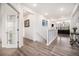 Bright hallway with hardwood floors, leading to an open-concept living space at 11346 Kittredge St, Commerce City, CO 80022