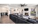 Open-concept living room with a fireplace, built-in shelving, and hardwood floors at 11346 Kittredge St, Commerce City, CO 80022