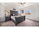 Main bedroom with large bed, tray ceiling, neutral color palette, and natural light at 11346 Kittredge St, Commerce City, CO 80022