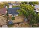 Aerial view of the home featuring a spacious backyard, covered patio, fire pit area, shed, and mature trees at 7911 Raleigh Pl, Westminster, CO 80030